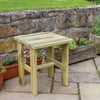 Natural wooden outdoor side table in garden patio with flower pots and stone wall, perfect for outdoor living and garden decor.