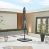 Modern outdoor patio with grey umbrella, potted plants, decorative lanterns, and contemporary design elements, perfect for outdoor living and garden decor.
