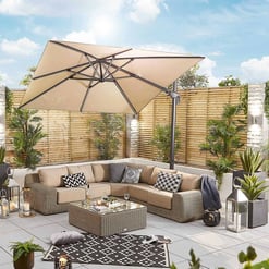 Elegant outdoor patio with beige sectional sofa, black-and-white patterned pillows, large beige patio umbrella, lush potted plants, lanterns, and a cozy black-and-white geometric rug, perfect for backyard entertaining.