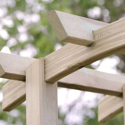 Natural wooden garden arbor with detailed craftsmanship, perfect for enhancing your outdoor space with stylish garden structures.