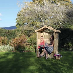 Cozy wooden garden shed with lattice design, perfect for outdoor relaxation and storage, surrounded by lush greenery and vibrant flowers. Ideal for enhancing garden aesthetics and functional outdoor space.