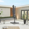Modern outdoor patio with a large gray umbrella, potted plants, ambient lighting, and decorative lanterns, showcasing stylish home and garden outdoor living space.