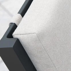 Soft beige outdoor furniture cushion with black metal frame, perfect for garden and patio decor.