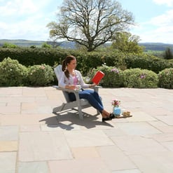 Peaceful outdoor patio with garden views, perfect for relaxing and enjoying coffee, flowers, and sunshine. Ideal for home and garden enthusiasts seeking outdoor relaxation spaces.