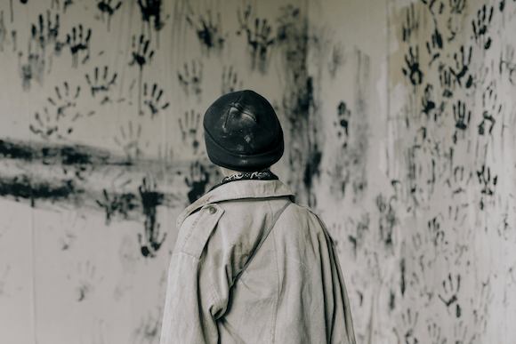 Karif Battle, founder of Theoretical Fiends LLC, got this photo, by Cottonbro Studio, from Pexels. In an eerie room, a boy faces a wall covered in supernatural black hand prints.