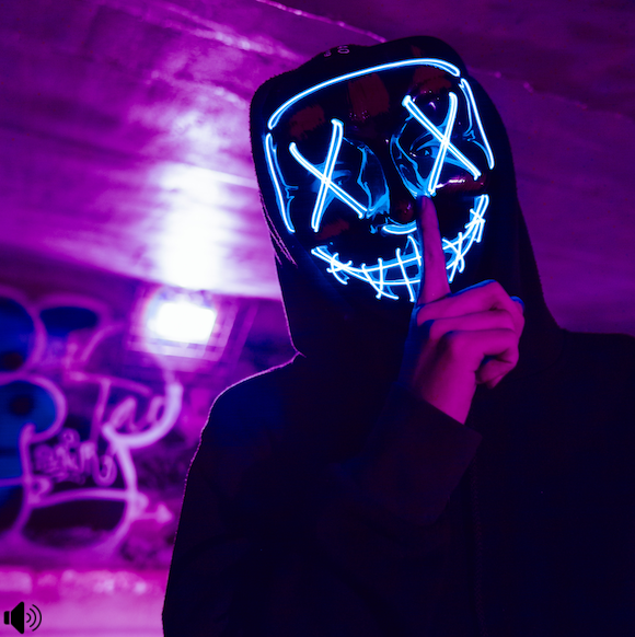 Karif Battle, founder of Theoretical Fiends LLC, got this photo, by Photo by Ty Huynh, from Pexels. In a purple lit subway tunnel, a hoodied-up figure with neon features puts a finger before his mouth. Shhh.