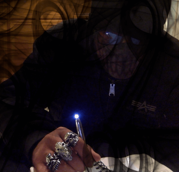 Karif Battle, founder of Theoretical Fiends LLC, is writing with the Muse, surrounded by dark supernatural smoke