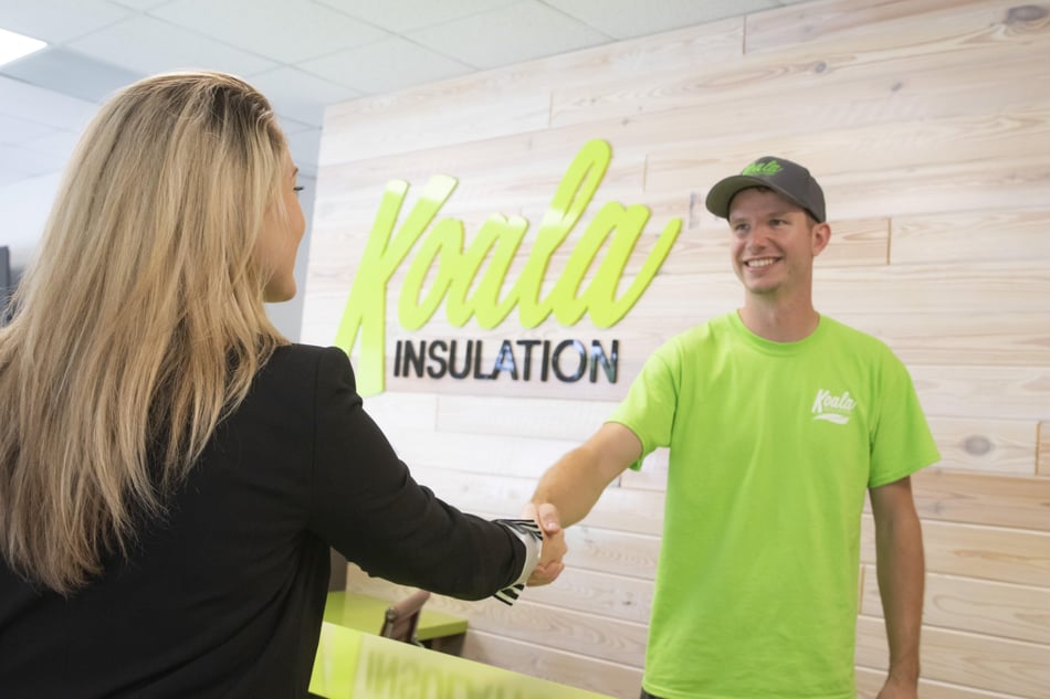Professional handshake symbolizing a successful agreement for home insulation services and property improvement.