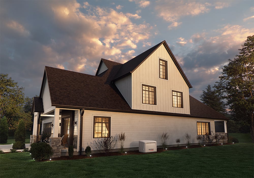 residential home at dusk lit up with a generac generator beside the home