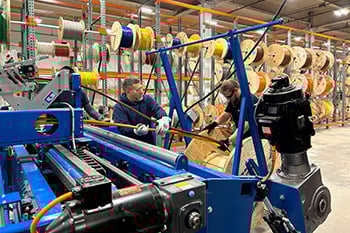 men paralleling wire in a electrical wire warehouse
