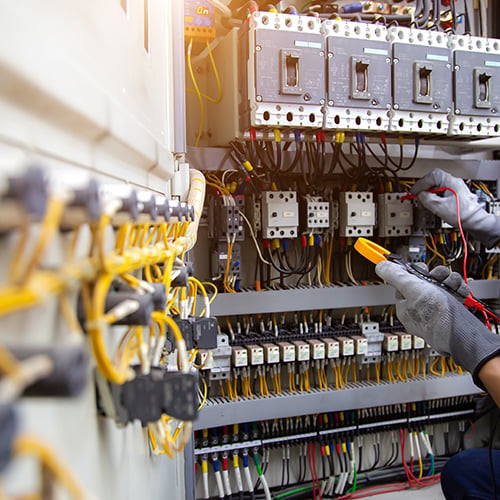Electrical service technician use electricity measuring tools equipment checking electric current circuit breaker terminal panel and cable wiring main power distribution board for maintenance system