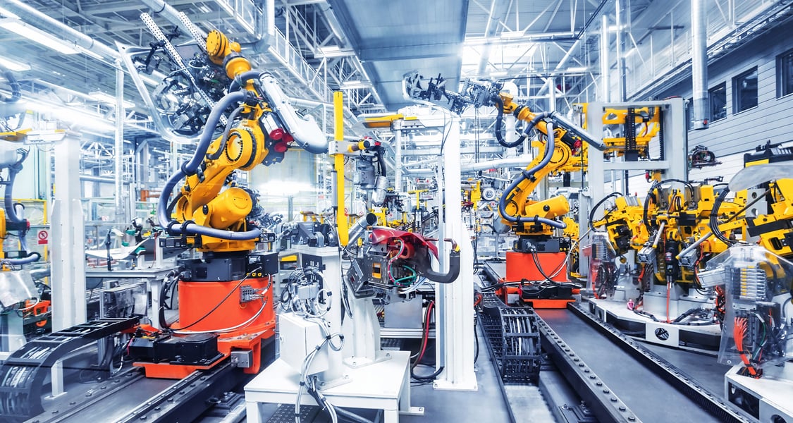 robotic arms in a car plant
