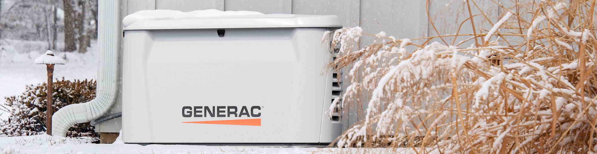generac generator beside a building in the snow