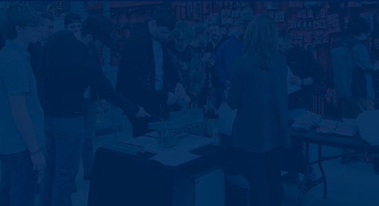 counter event with people gathering around product with a dark blue overlay