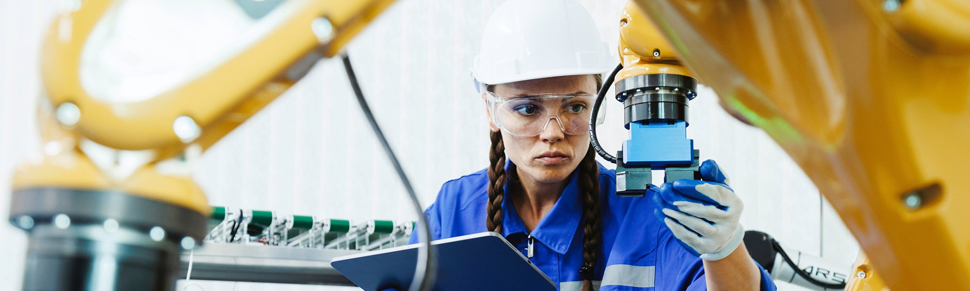 female automation machine engineer student study and inspection control robot arm machine in university or factory workshop. AI robot technology are new innovation trend for manufacturing in industry