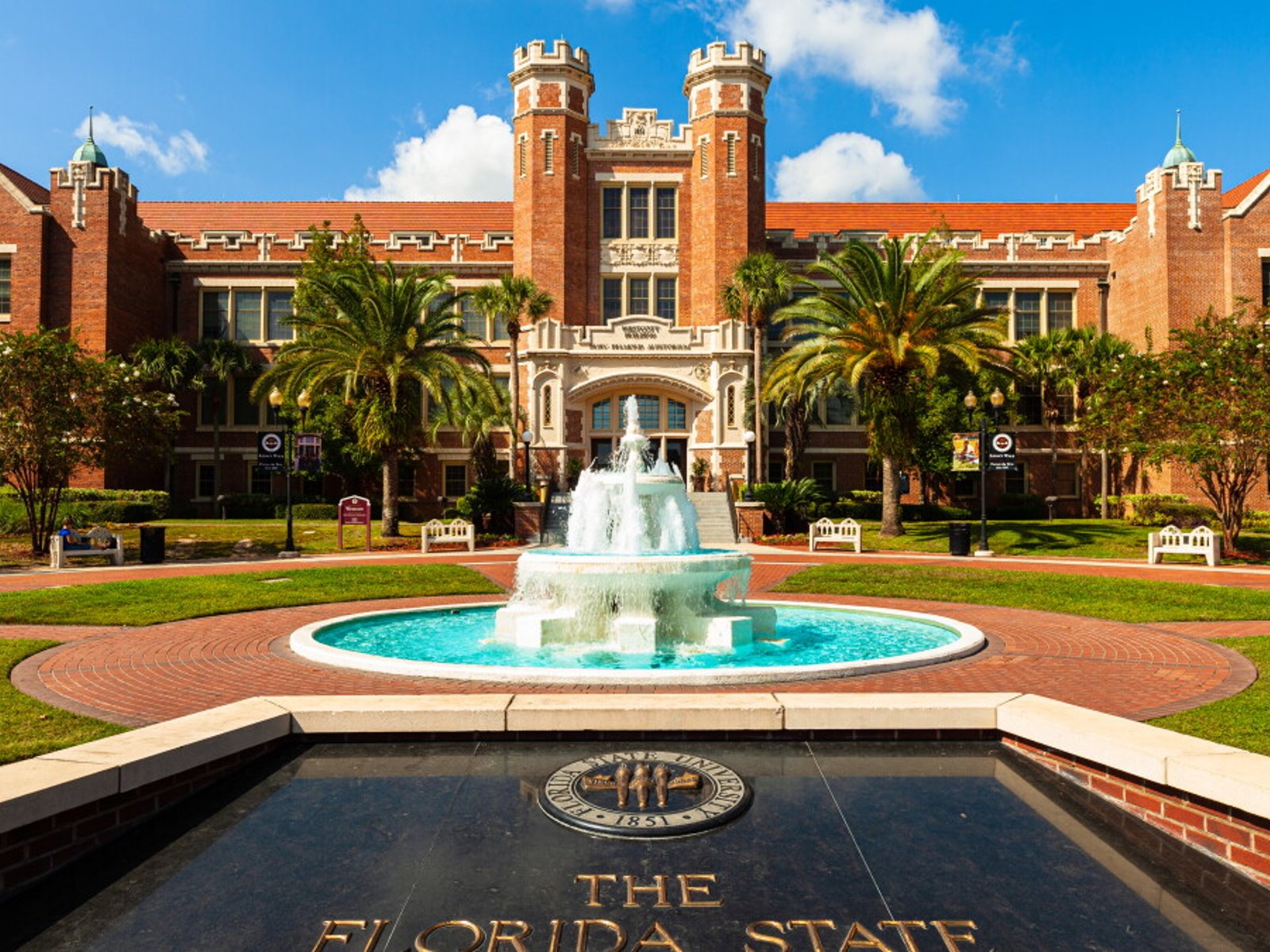 Westcott Building and fountain on the Florida State University campus under a bright blue sky.