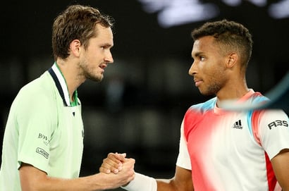Felix Auger Aliassime hands Daniil Medvedev