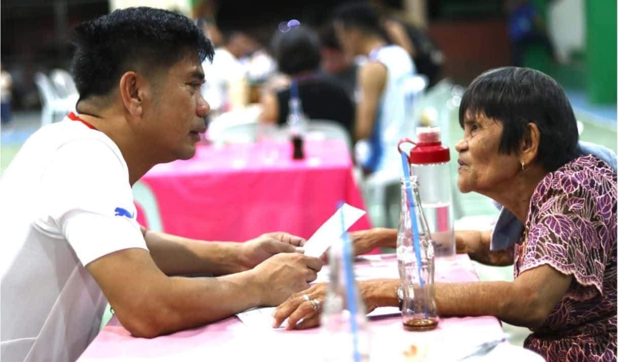 El vicealcalde de Butuán Lawrence Fortun (izquierda) conversa en puro butuanon con una mujer de 84 años en Barangay Babag, Ciudad de Butuán. Foto: Ivy Marie Mangadlao