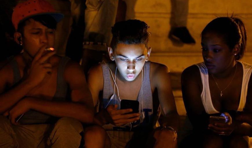 Young Cubans at one of the pay-for WiFi hotspots in Havana.
