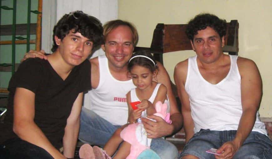 A young cuban man and his two fathers