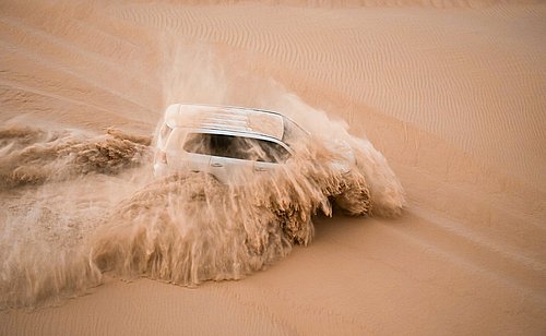 Thrilling dune bashing experience in Al Khatim Desert during evening safari adventure in Abu Dhabi with 4x4 off-road drives