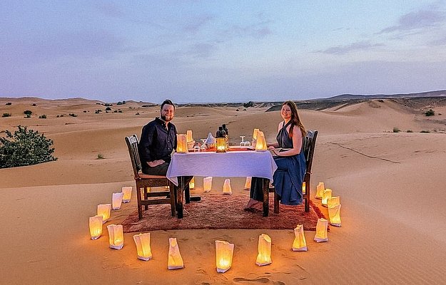 Private luxury dune dinner in Abu Dhabi with exclusive seating, romantic decor, and panoramic desert views