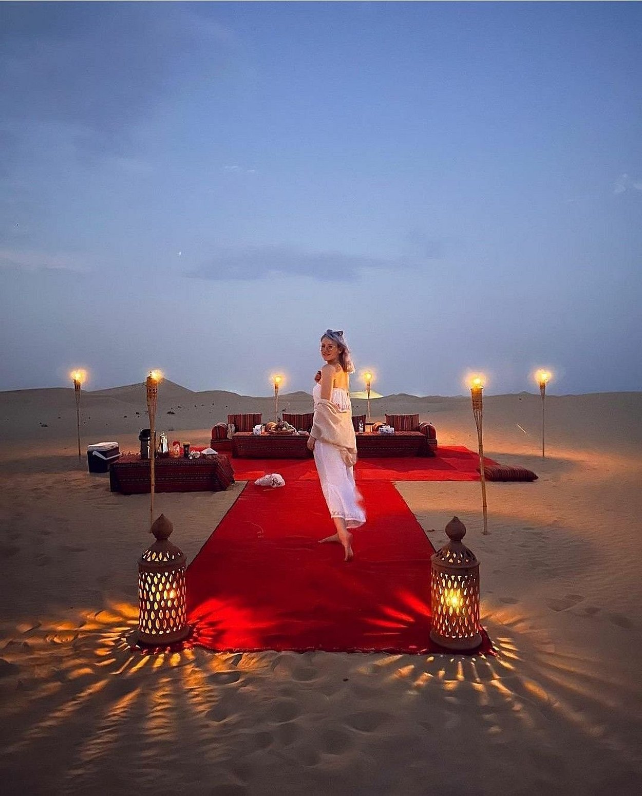 Romantic private dune dinner in Abu Dhabi with candlelight setup, luxury seating, and exclusive desert ambiance