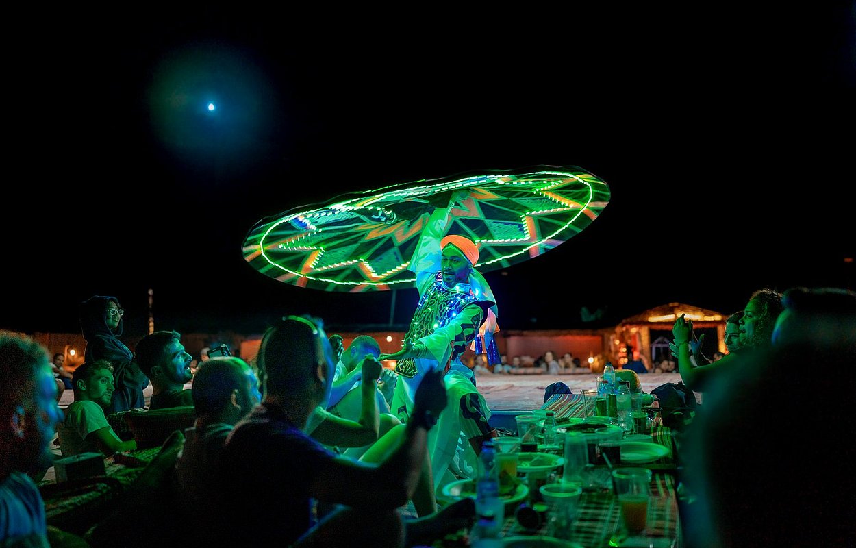Tanoura dance performance at Abu Dhabi desert camp during evening safari