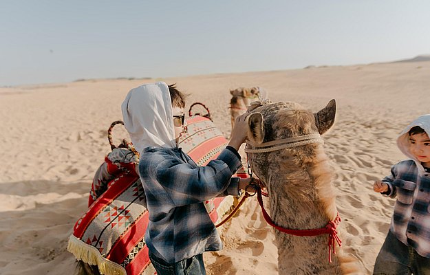 Kids camel ride Abu Dhabi desert safari tour