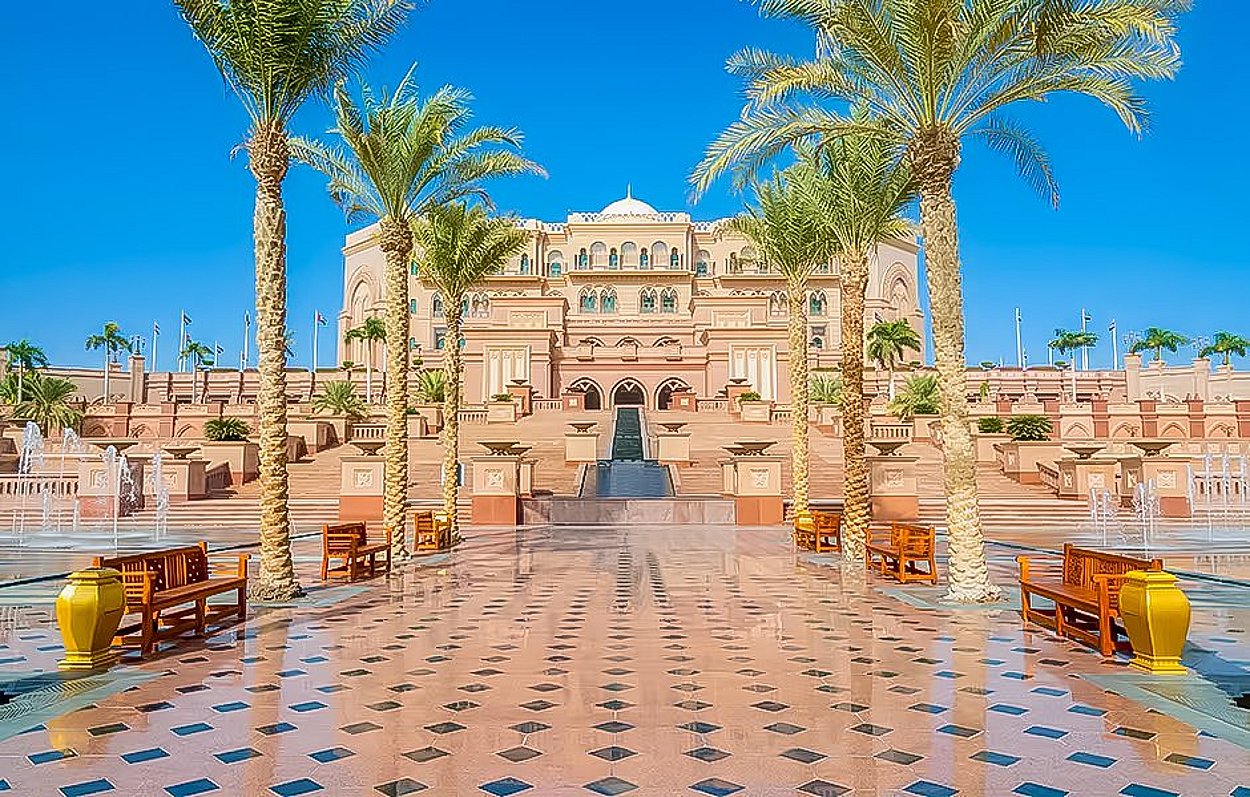 Emirates Palace exterior with palm-lined entrance in Abu Dhabi