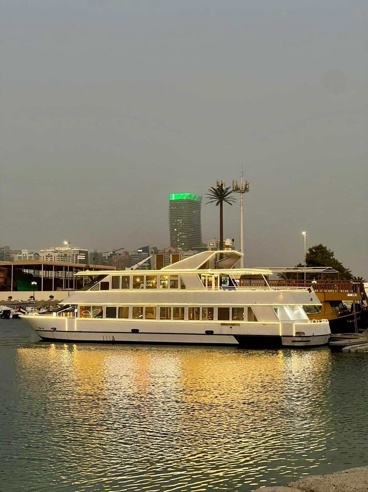 Luxury Yacht Sailing Along Abu Dhabi Corniche During Ramadan Evening