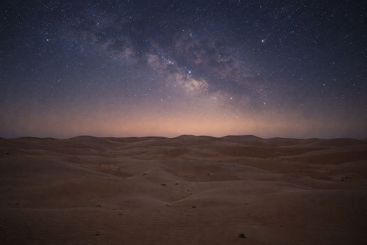 Milky Way galaxy visible above the desert dunes during Al Quaa Night Desert Safari Tour Abu Dhabi