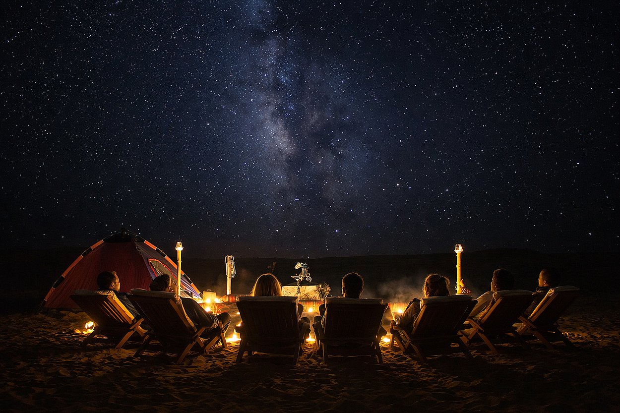 Group relaxing under the Milky Way during Al Quaa overnight desert camping tour Abu Dhabi