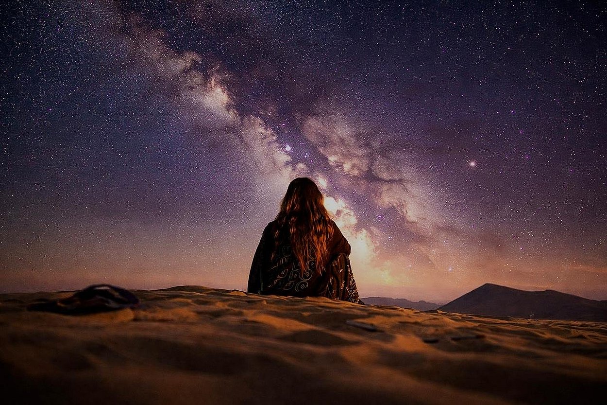 Traveler watching the Milky Way galaxy during Al Quaa Milky Way Night Desert Safari Tour in Abu Dhabi