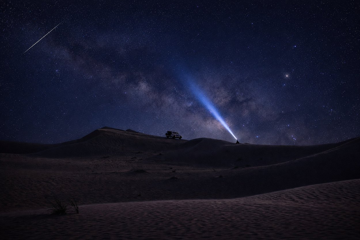Milky Way night sky above Al Quaa desert dunes during stargazing safari in Abu Dhabi