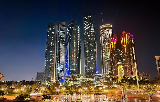 Etihad Towers and Abu Dhabi skyline lit up at night