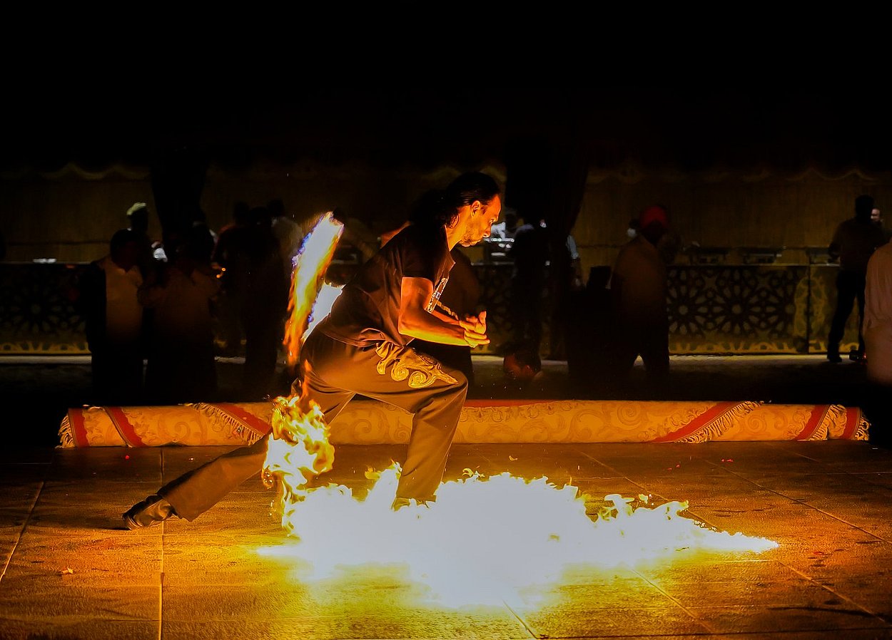 Performer showcasing a dramatic fire dance act