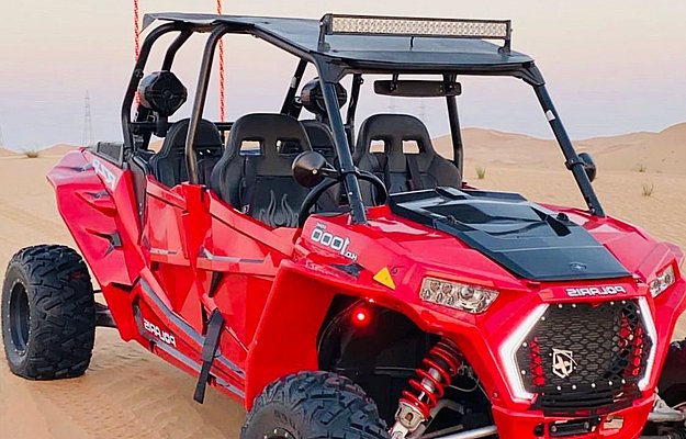 Red Polaris RZR dune buggy in the Abu Dhabi desert