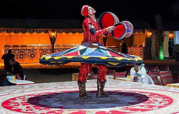 Tanoura dancer spinning with colorful LED costume
