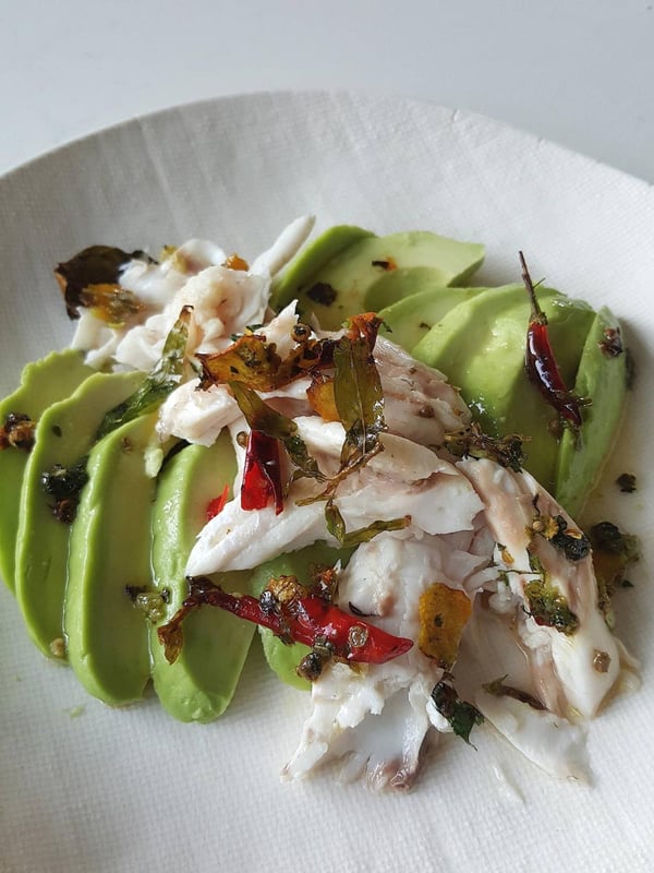 Baked fish with aromatics on avocado