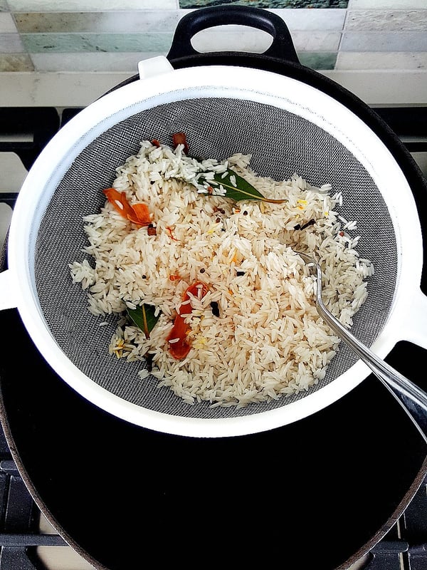 Blanching rice for biriani.