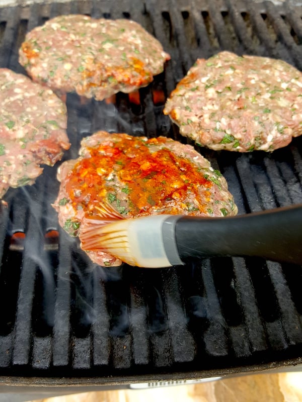 Grilling lamb burgers.