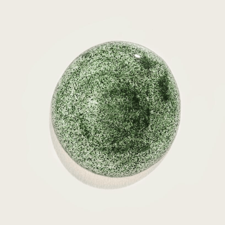 One serving of AG1 powder in a shallow dish, photographed from above