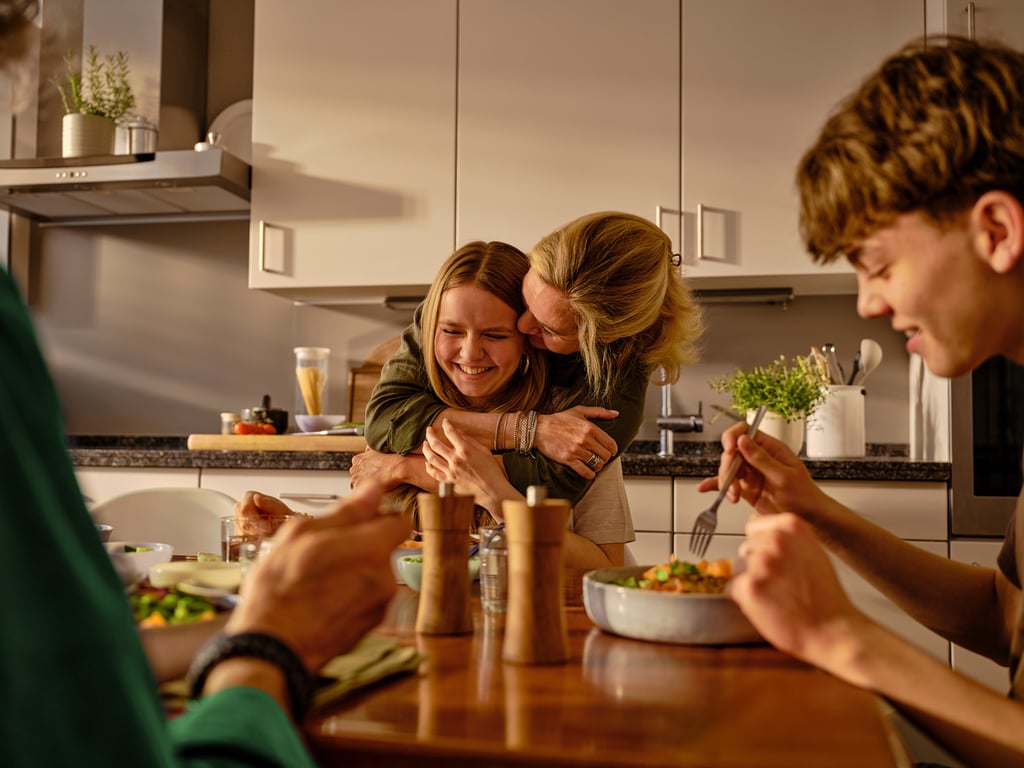 A family serving dinner from one pan in the middle of the table