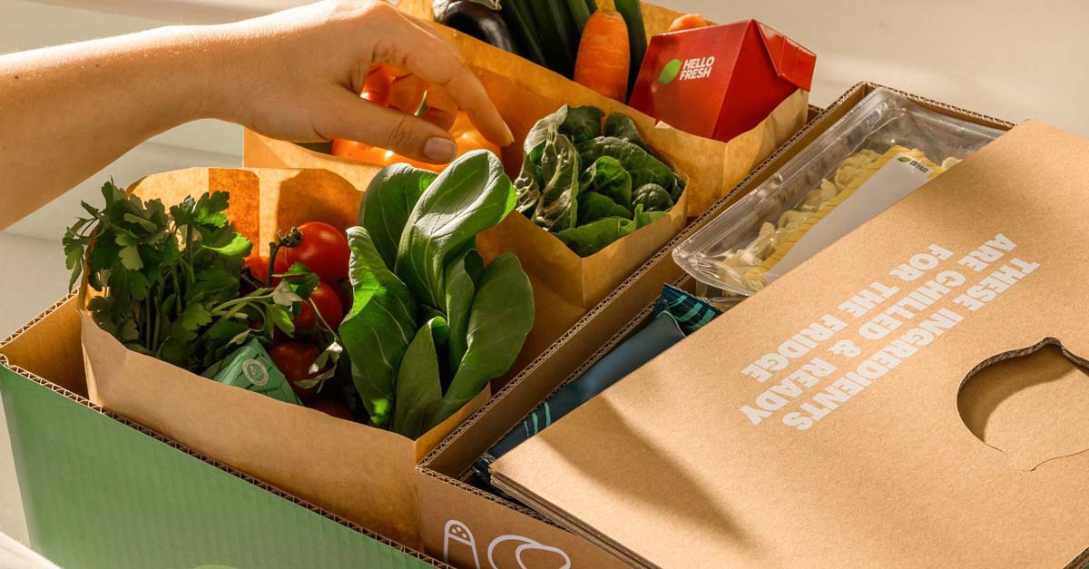 An open HelloFresh box with each recipe bagged separately
