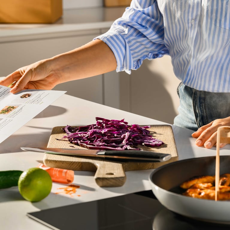 A pan mid-recipe on the hob with ingredients laid out beside it