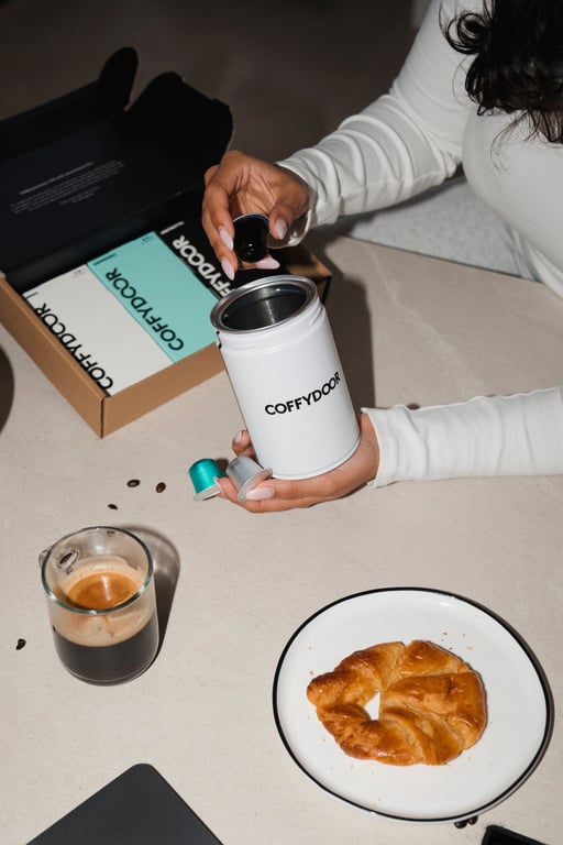 An opened Coffydoor capsule showing the ground coffee inside