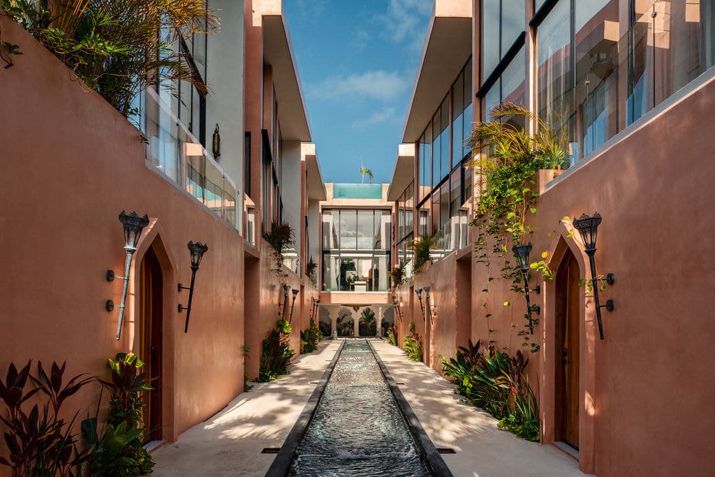 Walkway with arched doors and planting