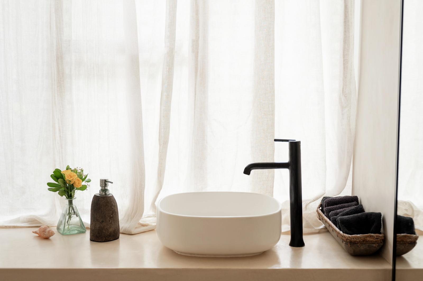Basin set against a linen curtain