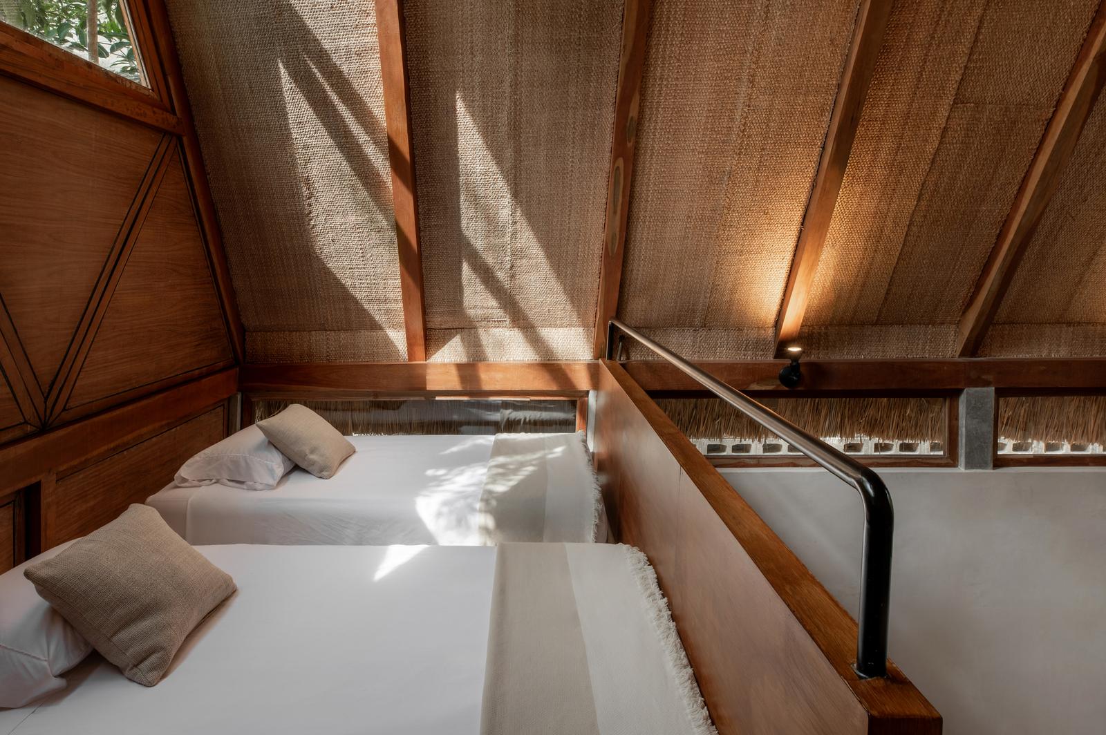 Mezzanine twin beds with the timber roof structure overhead